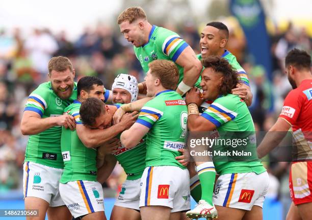 Jack Wighton of the Raiders celebrates scoring a try with team mates during the round nine NRL match between the Canberra Raiders and Dolphins at...
