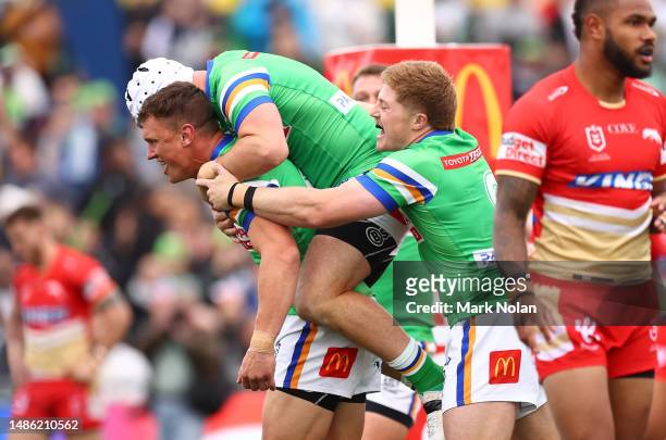 Jack Wighton of the Raiders celebrates scoring a try with team mates during the round nine NRL match between the Canberra Raiders and Dolphins at...