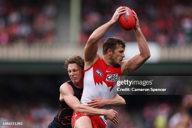 Luke Parker of the Swans is tackled by Lachie Whitfield of the Giants during the round seven AFL match between Sydney Swans and Greater Western...