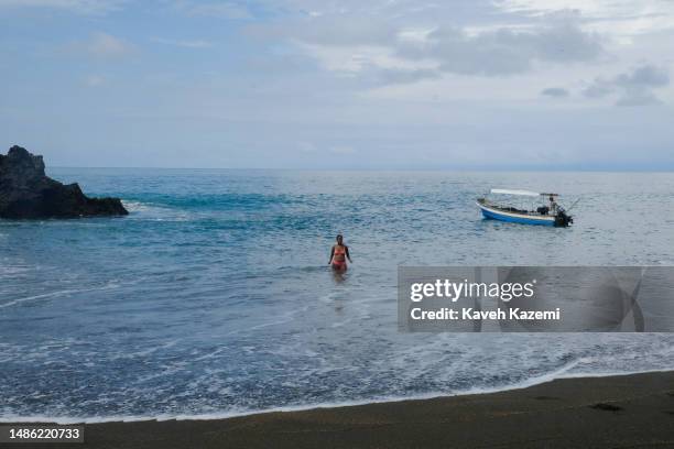 Tourist swimming in the sea on the Guachalito Beach on January 19, 2023 in Nuqui, Colombia.