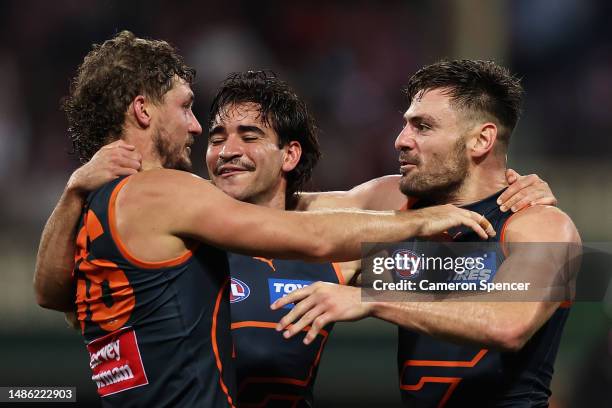 Toby Bedford, Harry Perryman and Stephen Coniglio of the Giants celebrate winning the round seven AFL match between Sydney Swans and Greater Western...