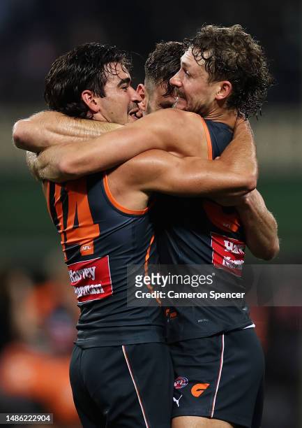 Toby Bedford, Harry Perryman and Stephen Coniglio of the Giants celebrate winning the round seven AFL match between Sydney Swans and Greater Western...