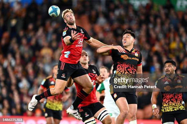 Braydon Ennor of the Crusaders attempts to secure the ball during the round 10 Super Rugby Pacific match between Chiefs and Crusaders at FMG Stadium...