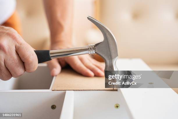 closeup of hammer hitting nail - hammer and nail fotografías e imágenes de stock