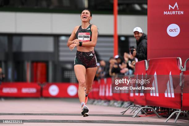 Maria Fernanda Montoya of Colombia reacts as they cross the finish line in the Women's 21.1km Race during the Adizero: Road To Records 2023 on April...