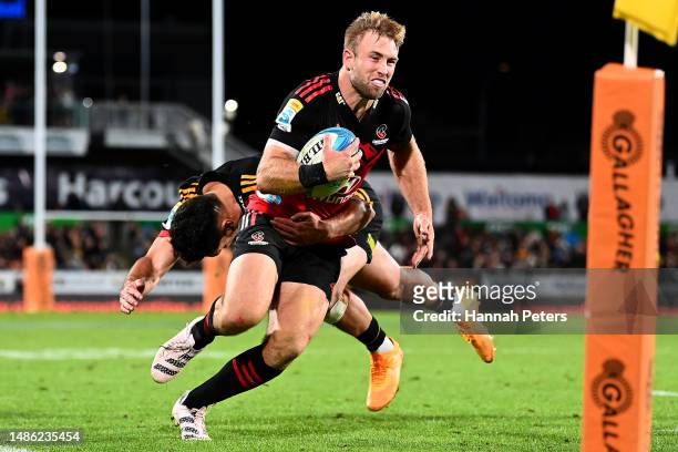 Braydon Ennor of the Crusaders charges forward during the round 10 Super Rugby Pacific match between Chiefs and Crusaders at FMG Stadium Waikato, on...