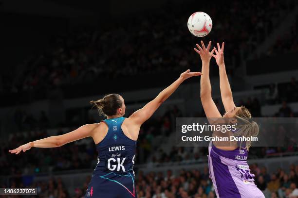 Donnell Wallam of the Firebirds and Olivia Lewis of the Vixens compete for the ball during the round seven Super Netball match between Melbourne...