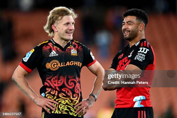 Damian McKenzie of the Chiefs and Richie Mo'unga of the Crusaders talk following the round 10 Super Rugby Pacific match between Chiefs and Crusaders...