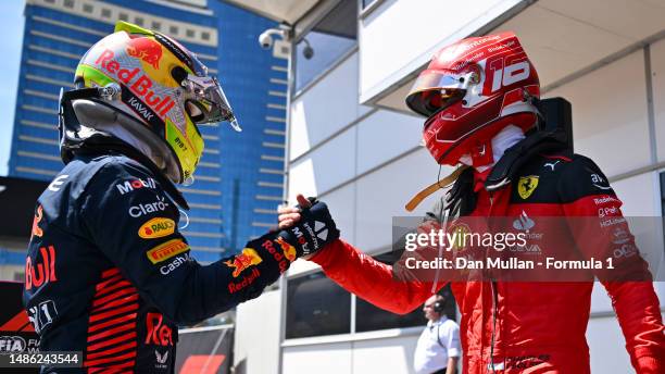 Pole position qualifier Charles Leclerc of Monaco and Ferrari and Second placed qualifier Sergio Perez of Mexico and Oracle Red Bull Racing shake...