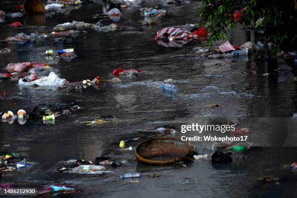 garbage can flows on water - polystyrene float stock pictures, royalty-free photos & images