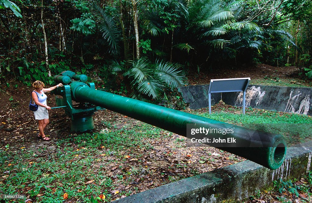 Tourist with cannon at War in the Pacific National Historic Park.