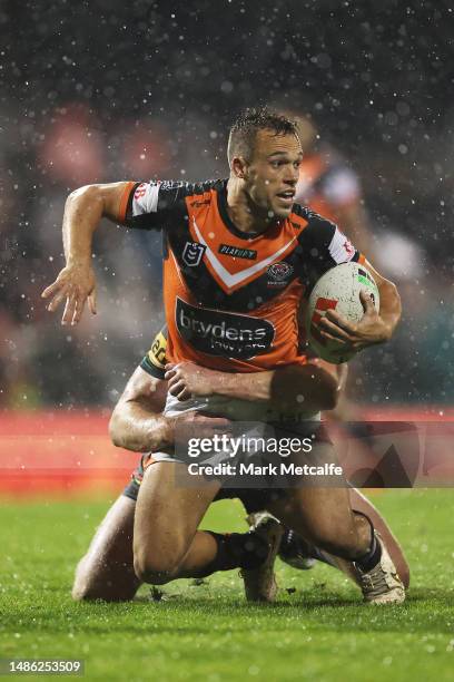 Luke Brooks of the Wests Tigers is tackled by Isaah Yeo of the Panthers during the round nine NRL match between Penrith Panthers and Wests Tigers at...