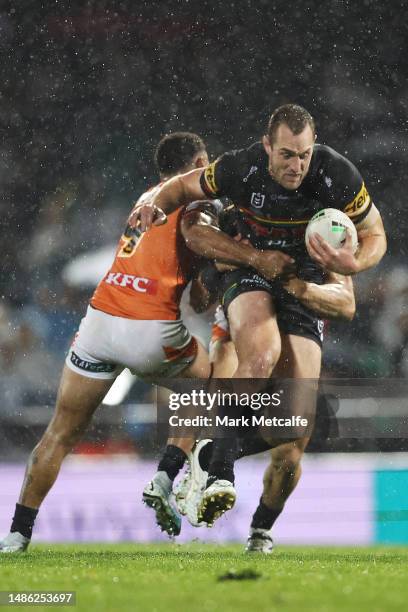 Isaah Yeo of the Panthers is tackled during the round nine NRL match between Penrith Panthers and Wests Tigers at Carrington Park on April 29, 2023...