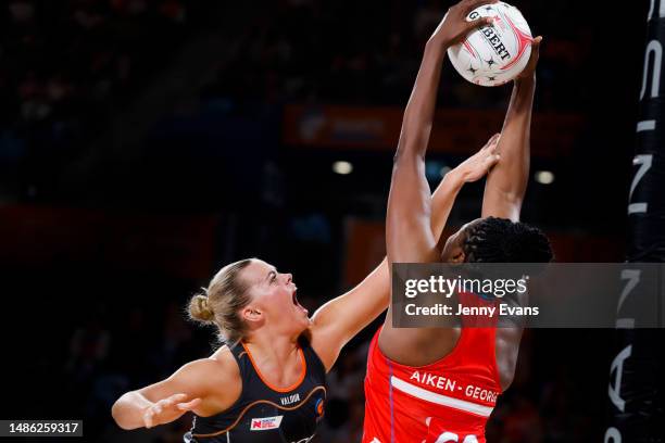Matilda McDonell of the Giants defends as Romelda Aiken-George of the Swifts shoots during the round seven Super Netball match between Giants Netball...
