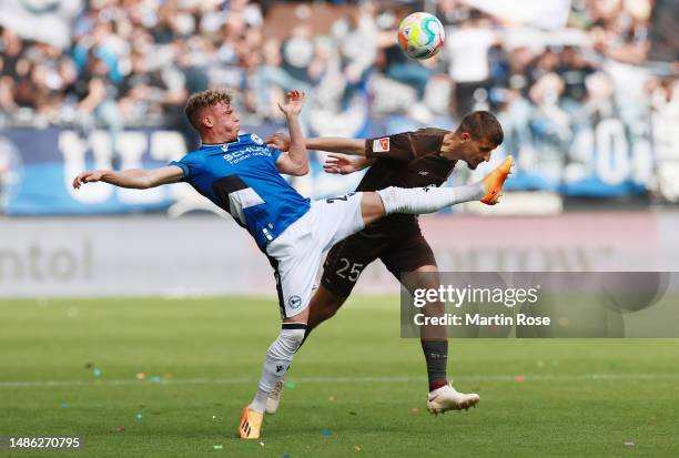 Robin Hack of DSC Arminia Bielefeld battles for possession with Adam Dzwigaa of FC St. Pauli during the Second Bundesliga match between FC St. Pauli...