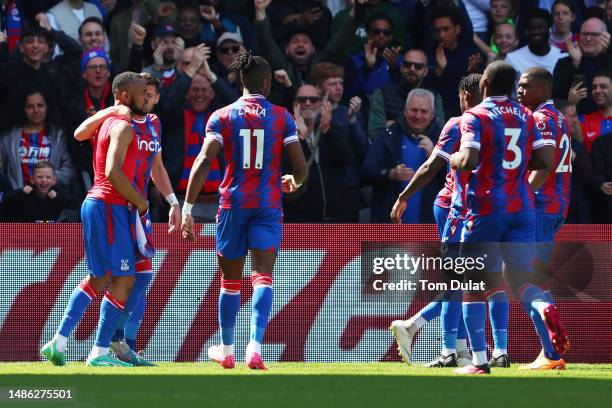 Jordan Ayew of Crystal Palace celebrates with teammates after scoring the team's first goal during the Premier League match between Crystal Palace...