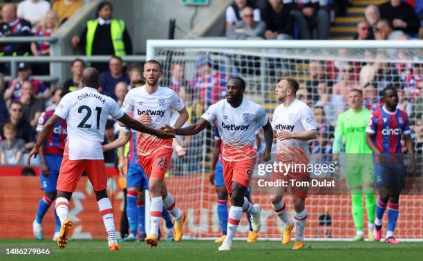 Michail Antonio of West Ham United celebrates with teammate Angelo Ogbonna after scoring the team's second goal during the Premier League match...