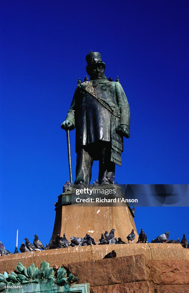 Pigeons sitting on a statue of Paul Kruger, a leader of the Boers, in Church Square