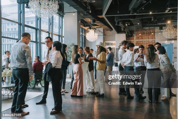 group of multiracial asian business participants casual chat after successful conference event - storföretag bildbanksfoton och bilder