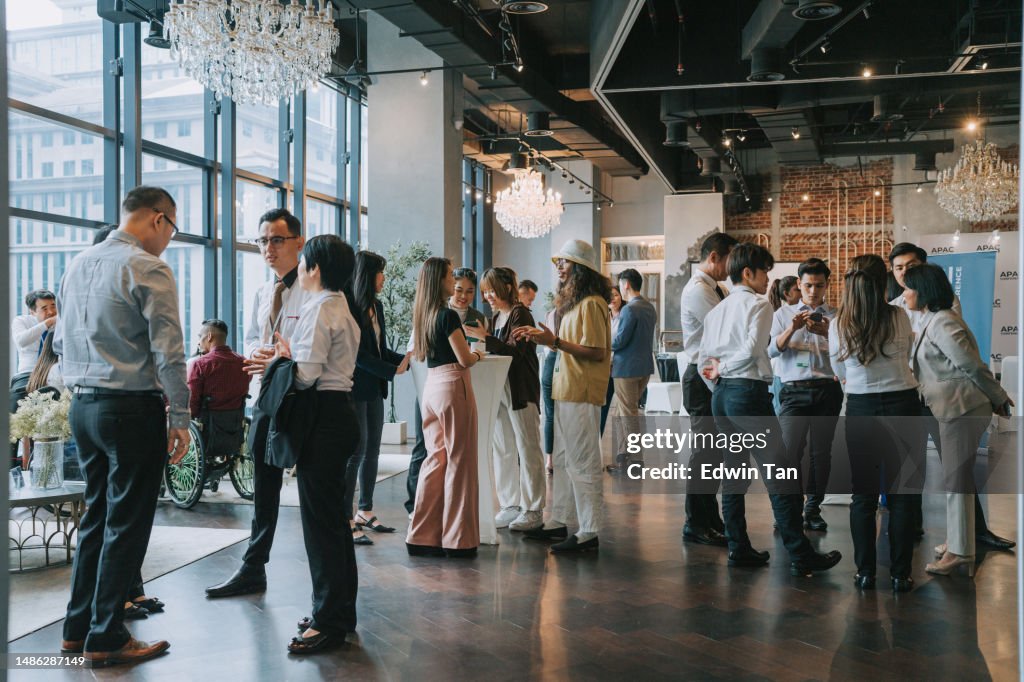 Group of multiracial Asian business participants casual chat after successful conference event