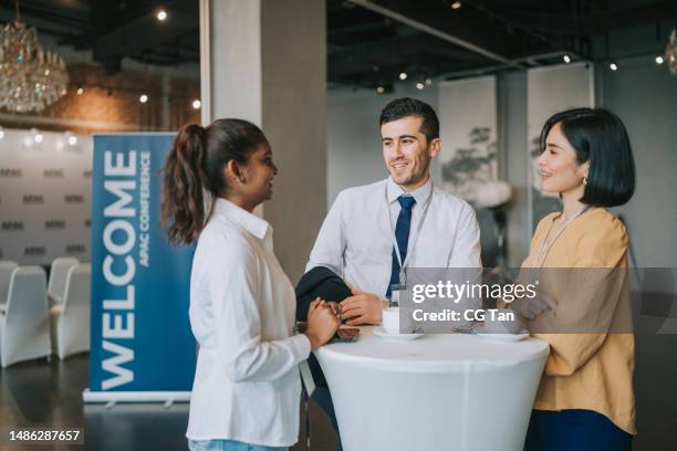 uomini d'affari multietnici asiatici parlano durante una pausa caffè in una conferenza aziendale seminar - pausa caffè foto e immagini stock