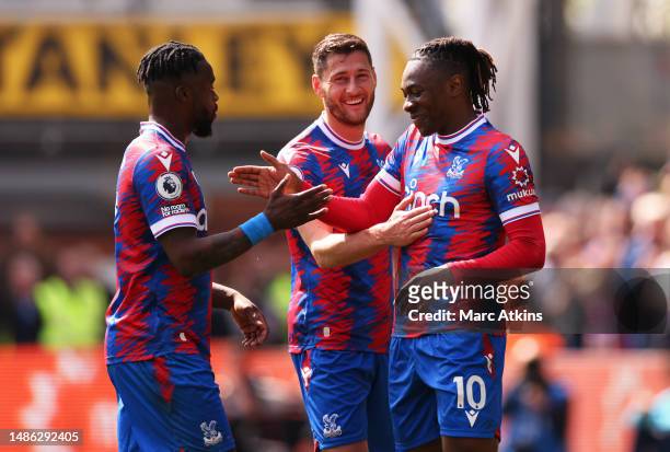 Eberechi Eze of Crystal Palace celebrates with teammates Joel Ward and Jeffrey Schlupp after scoring the team's fourth goal from a penalty kick...