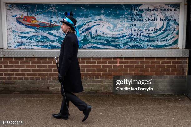 Man in goth clothing walks past a wall painting during the Whitby Goth Weekend on April 29, 2023 in Whitby, England. The original Whitby Goth Weekend...