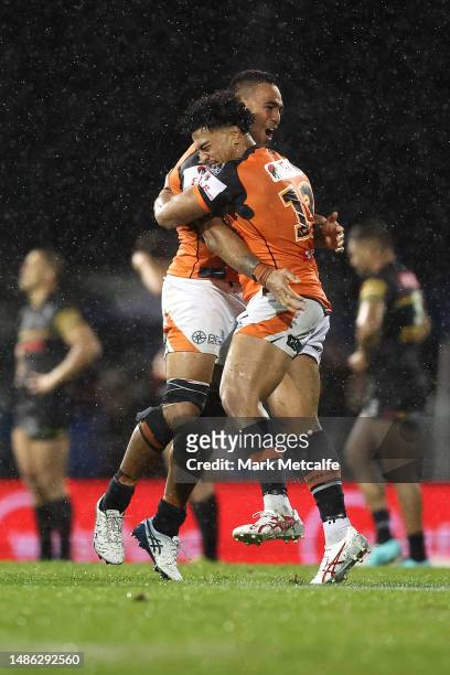 Fonua Pole and Joe Ofahengaue of the Wests Tigers celebrate victory during the round nine NRL match between Penrith Panthers and Wests Tigers at...