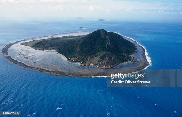 an aerial view of an island in the torres strait, surrounded by a shallow reef. - torres strait ストックフォトと画像