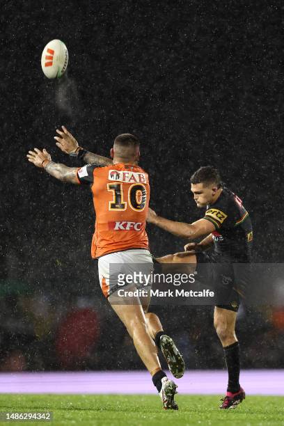 Nathan Cleary of the Panthers kicks as David Klemmer of the Wests Tigers attempts a charge down during the round nine NRL match between Penrith...