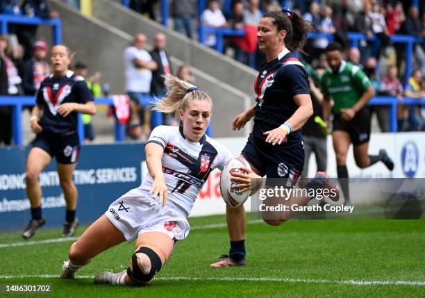 Tamzin Renouf of England scores a first half tryduring the Mid-Season Rugby League International between England and France at The Halliwell Jones...