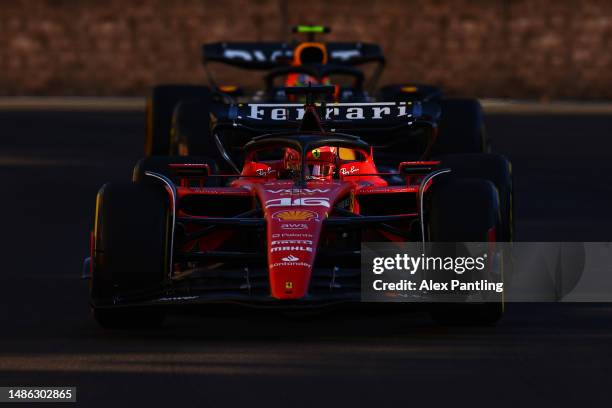 Charles Leclerc of Monaco driving the Ferrari SF-23 leads Sergio Perez of Mexico driving the Oracle Red Bull Racing RB19 on track during the Sprint...