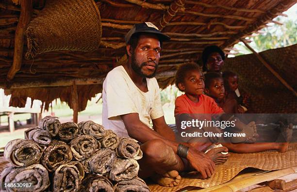 man selling crocodile skins - papua new guinea market stock pictures, royalty-free photos & images