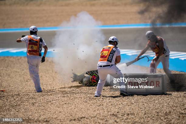 Track marshals extinguish the burning motorcycle of Marco Bezzecchi of Italy and Mooney VR46 Racing Team after the big crash during the Sprint of the...