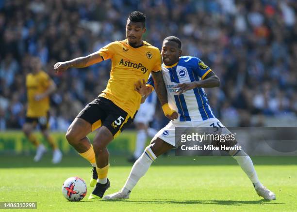 Mario Lemina of Wolverhampton Wanderers is challenged by Pervis Estupinan of Brighton & Hove Albion during the Premier League match between Brighton...