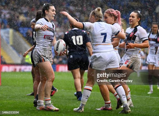 Leah Burke of England celebrates scoring her 5th try with teammates during the Mid-Season Rugby League International between England and France at...