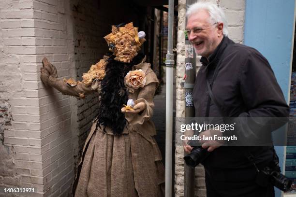 Person dressed in costume reacts with a photographer during the Whitby Goth Weekend on April 29, 2023 in Whitby, England. The original Whitby Goth...