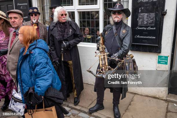 Man wearing a steampunk outfit stands outside a bar during the Whitby Goth Weekend on April 29, 2023 in Whitby, England. The original Whitby Goth...