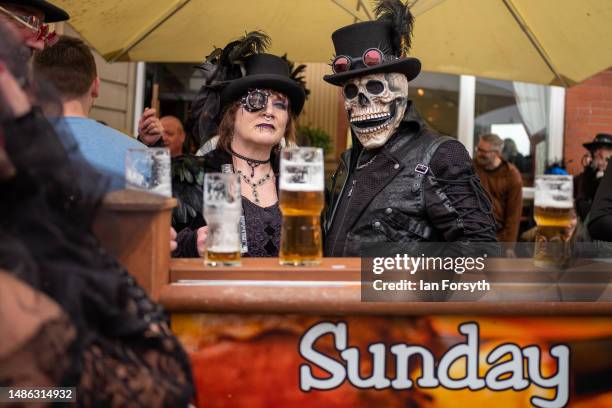 Couple in gothic clothing have a pint in a bar during the Whitby Goth Weekend on April 29, 2023 in Whitby, England. The original Whitby Goth Weekend...