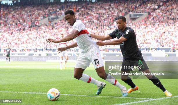 Dan-Axel Zagadou of VfB Stuttgart is challenged by Alassane Plea of Borussia Moenchengladbach during the Bundesliga match between VfB Stuttgart and...