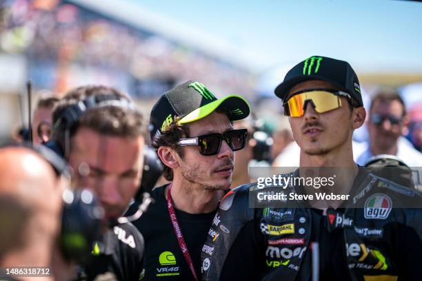 MotoGP Legend Valentino Rossi of Italy speaks to half brother Luca Marini of Italy and Mooney VR46 Racing Team at the starting grid during the Sprint...