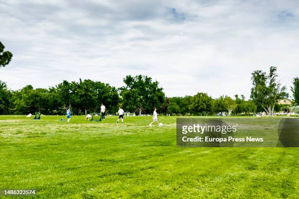 Several people play soccer in the Juan Carlos I Park, on 29 April, 2023 in Madrid, Spain. The State Meteorological Agency has announced for today,...