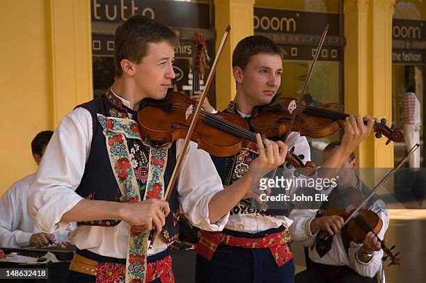 violinists in traditional music group. - karlovy vary stock-fotos und bilder