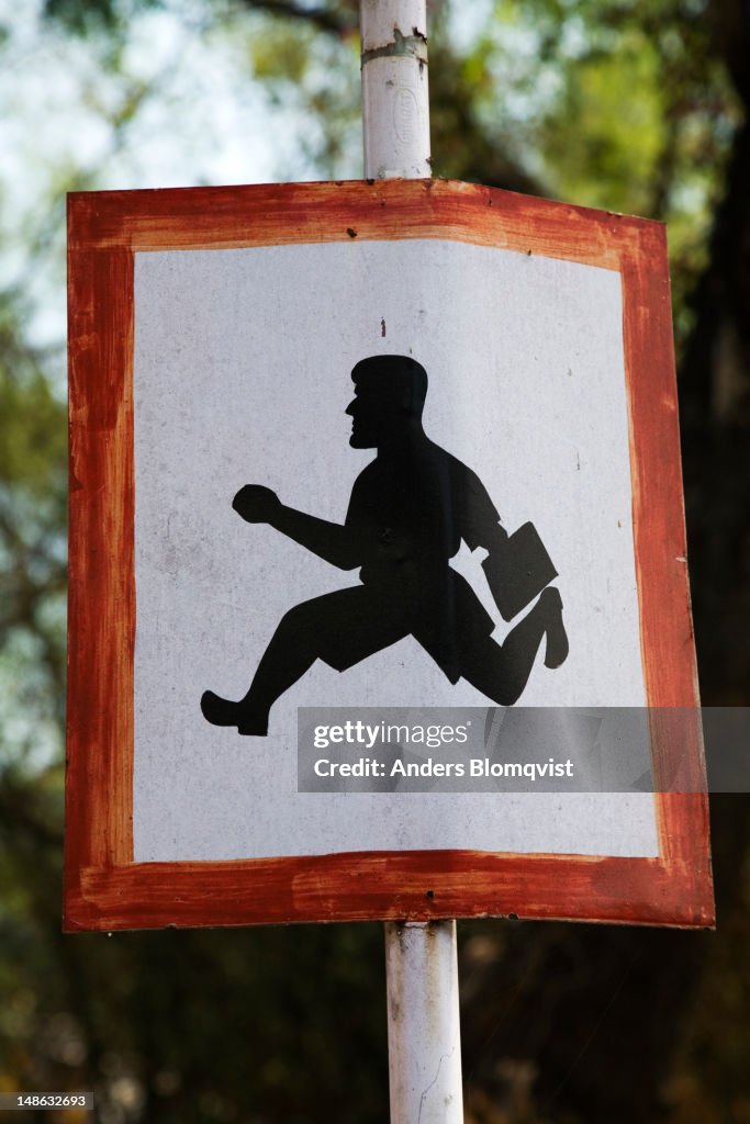 Warning sign for running schoolkids - or running businesswallahs.
