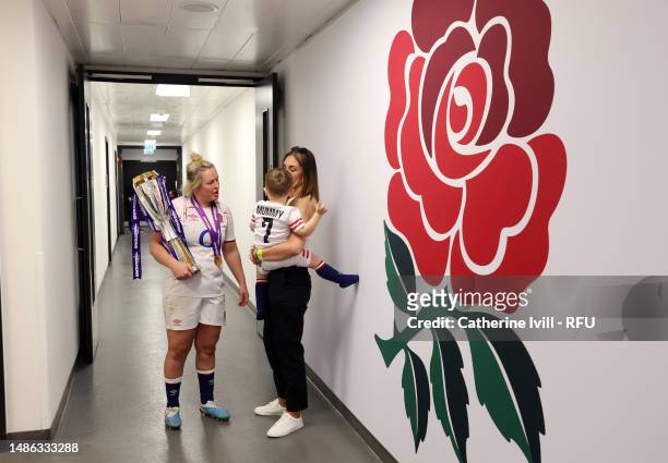 Marlie Packer of England holds the trophy as she talks to her family in the tunnel after the TikTok Women's Six Nations match between England and...