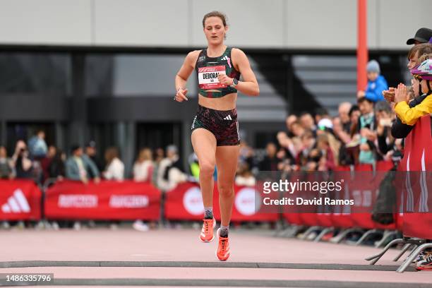 Deborah Schoeneborn of Germany crosses the finish line in the Women's 5km race during the Adizero: Road To Records 2023 on April 29, 2023 in...