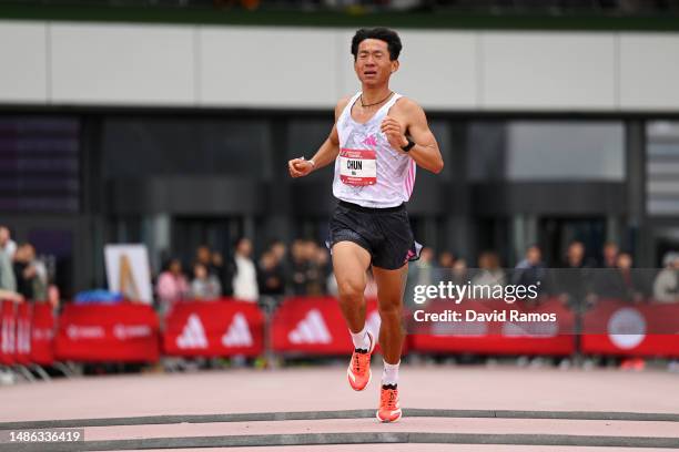 Chun Luo of China crosses the finish line in the Men's 5km race during the Adizero: Road To Records 2023 on April 29, 2023 in Herzogenaurach, Germany.