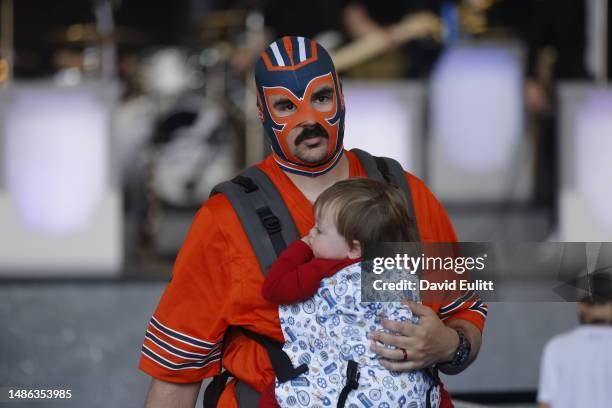 Chicago Bears fan carries his daughter during the 2023 NFL Draft at Union Station on April 29, 2023 in Kansas City, Missouri.