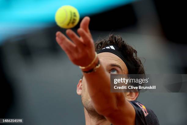 Dominic Thiem of Austria serves against Stefanos Tsitsipas of Greece during the Men's Round of 64 match on Day Six of the Mutua Madrid Open at La...