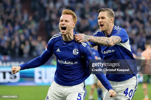 Sepp van den Berg of FC Schalke 04 celebrates with teammate Sebastian Polter after scoring the team's first goal during the Bundesliga match between...